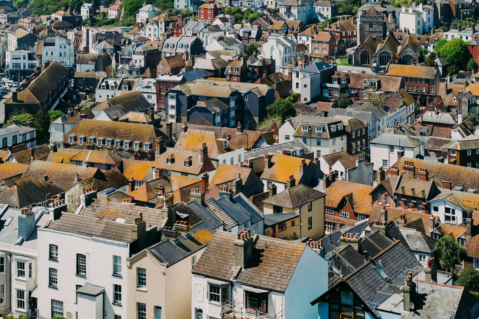 Aerial view of the historic rooftops in Hastings, England showcasing diverse architecture and vibrant colors.