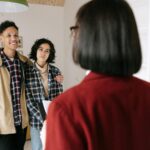 Young couple discussing real estate options with an agent indoors, highlighting home buying process.